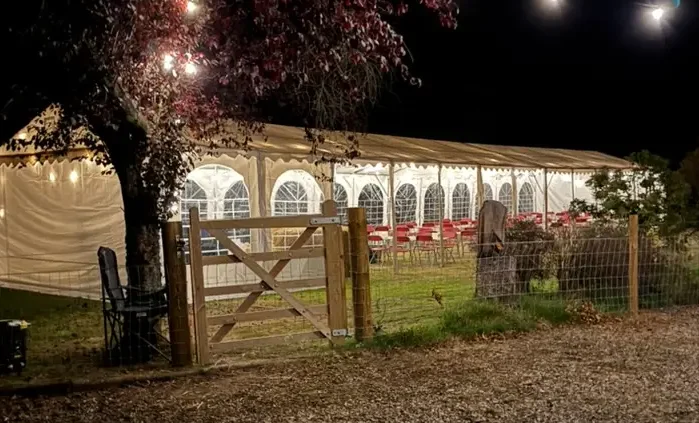 Relaxed twilight wedding ceremony in Scotland with marquee and soft lighting celebrant